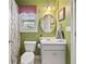 Cozy bathroom featuring a white vanity, charming mirror, and soft green walls at 21 Cass Station Pass Nw Pass, Cartersville, GA 30121