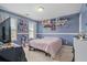 Cozy bedroom featuring calming blue walls, shelving, and natural light from two windows at 21 Cass Station Pass Nw Pass, Cartersville, GA 30121