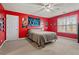 Spacious bedroom featuring bright red walls, neutral carpet, and a ceiling fan at 21 Cass Station Pass Nw Pass, Cartersville, GA 30121