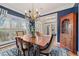 Elegant dining room features dark blue walls, wood floors, large windows, and a stylish chandelier at 21 Cass Station Pass Nw Pass, Cartersville, GA 30121