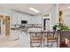 Bright kitchen featuring white cabinets, granite countertops, a breakfast bar, and tiled flooring at 21 Cass Station Pass Nw Pass, Cartersville, GA 30121