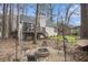 Inviting backyard featuring a stone fire pit, deck, and swing set at 3214 Country Walk Dr, Powder Springs, GA 30127