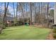 Large backyard with artificial turf, wooden fence and playset at 3214 Country Walk Dr, Powder Springs, GA 30127