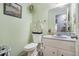 Powder room featuring granite countertop and decorative mirror at 3214 Country Walk Dr, Powder Springs, GA 30127