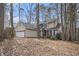 Charming two-story home with brick accents and a two-car garage nestled amongst mature trees at 3214 Country Walk Dr, Powder Springs, GA 30127