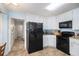 Well-lit kitchen featuring granite countertops and modern black appliances at 3214 Country Walk Dr, Powder Springs, GA 30127