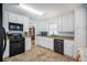 Well-lit kitchen featuring granite countertops and modern black appliances at 3214 Country Walk Dr, Powder Springs, GA 30127