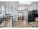 Bright kitchen with granite counters, stainless steel sink, and adjacent breakfast nook at 3214 Country Walk Dr, Powder Springs, GA 30127