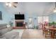 Bright living room featuring a brick fireplace, comfortable seating, and plenty of natural light at 3214 Country Walk Dr, Powder Springs, GA 30127