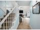 Welcoming foyer and staircase leading to living room with vaulted ceiling and cozy fireplace at 3214 Country Walk Dr, Powder Springs, GA 30127