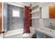 This bathroom features gray tile, a shower-tub combo, open shelving, and vanity at 562 Formwalt Sw St # 5, Atlanta, GA 30312