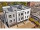 Aerial view showcasing modern townhomes with gray and white exteriors and brick driveways at 1237 Memorial Se Dr # 304, Atlanta, GA 30316