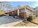 Brick home featuring a driveway, mature trees and a fenced area at 1722 Detroit Nw Ave, Atlanta, GA 30314