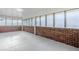 Enclosed sunroom featuring brick walls and many windows to provide ample natural light at 1722 Detroit Nw Ave, Atlanta, GA 30314