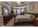 Light-filled main bedroom with tray ceiling, warm tones, and lots of natural light at 42 Windrush Dr, White, GA 30184