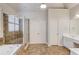 Spacious main bathroom featuring a soaking tub, glass shower, and tile floors at 5830 Wild Azalea Cv, Sugar Hill, GA 30518