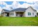 A covered patio complements the lush backyard, creating an inviting outdoor space for relaxation and entertainment at 1291 Pleasant Grove Church Rd, Villa Rica, GA 30180
