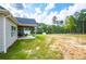 The home's backyard features an outdoor seating area, providing a serene space to enjoy the beauty of nature at 1291 Pleasant Grove Church Rd, Villa Rica, GA 30180