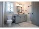 Modern bathroom features a vanity with gray cabinets, framed mirror, and marble floors at 1291 Pleasant Grove Church Rd, Villa Rica, GA 30180