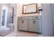 Bathroom features a marble floor, gray vanity, framed mirror, and brushed hardware at 1291 Pleasant Grove Church Rd, Villa Rica, GA 30180