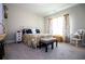 Bedroom features a white iron bed frame, wood floors, and natural light at 1291 Pleasant Grove Church Rd, Villa Rica, GA 30180