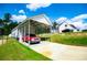 Carport with storage shed behind home, long driveway and parked vehicles at 1291 Pleasant Grove Church Rd, Villa Rica, GA 30180