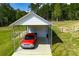 Aerial view of carport with storage shed and vehicle parked out front on concrete pad at 1291 Pleasant Grove Church Rd, Villa Rica, GA 30180