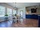 Bright dining area with large windows, modern lighting, and an open view to the living space at 1291 Pleasant Grove Church Rd, Villa Rica, GA 30180