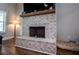 Living room with a large brick fireplace, wooden mantle, and a large hearth at 1291 Pleasant Grove Church Rd, Villa Rica, GA 30180