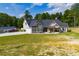 Beautiful single-story home with front porch, garage, additional building and spacious lawn at 1291 Pleasant Grove Church Rd, Villa Rica, GA 30180