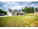 Spacious front yard showcasing a charming single-story home with an attached garage and well-maintained lawn at 1291 Pleasant Grove Church Rd, Villa Rica, GA 30180