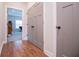 Hallway featuring wood floors, a large closet, and gray doors at 1291 Pleasant Grove Church Rd, Villa Rica, GA 30180