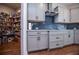 Pantry adjacent to kitchen boasts ample shelving and storage space, enhancing organization at 1291 Pleasant Grove Church Rd, Villa Rica, GA 30180