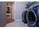 This is a bright laundry room with modern washer and dryer, providing a practical and convenient space for chores at 1291 Pleasant Grove Church Rd, Villa Rica, GA 30180