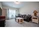 Cozy living room with a brown leather sofa, wood table, and natural light at 1291 Pleasant Grove Church Rd, Villa Rica, GA 30180
