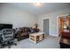 Neutral room features a brown leather sofa, a wood table, and carpet at 1291 Pleasant Grove Church Rd, Villa Rica, GA 30180