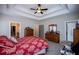 The bedroom has a ceiling fan, dresser, and easy access to a walk-in closet at 1291 Pleasant Grove Church Rd, Villa Rica, GA 30180