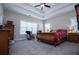 Bright bedroom features a ceiling fan, dresser, and a big bright window at 1291 Pleasant Grove Church Rd, Villa Rica, GA 30180