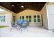 Covered patio with outdoor seating, great view of the backyard through windows and doors to the home at 1291 Pleasant Grove Church Rd, Villa Rica, GA 30180