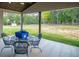 Covered patio featuring a ceiling fan, outdoor seating, and a view of the expansive backyard at 1291 Pleasant Grove Church Rd, Villa Rica, GA 30180
