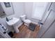 Bright powder room with hardwood floors, pedestal sink, and modern fixtures. Includes storage at 1291 Pleasant Grove Church Rd, Villa Rica, GA 30180