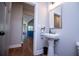 Bright powder room with hardwood floors, pedestal sink, and modern fixtures is conveniently accessible at 1291 Pleasant Grove Church Rd, Villa Rica, GA 30180