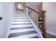 A staircase features wood treads and a decorative metal railing, adding a stylish touch to the home's interior at 1291 Pleasant Grove Church Rd, Villa Rica, GA 30180