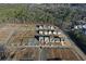 Aerial view of a community with new homes under construction and land lots being developed at 140 Kingsley Way, Acworth, GA 30102