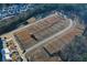 An aerial view shows land ready for development in a community bordered by mature trees at 140 Kingsley Way, Acworth, GA 30102