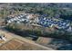 An aerial view showcases a neighborhood with modern homes nestled among trees and landscaping at 140 Kingsley Way, Acworth, GA 30102
