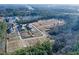 Aerial view showcasing a neighborhood under construction near wooded areas and available land lots at 140 Kingsley Way, Acworth, GA 30102