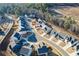 Aerial view of a new construction community with winding streets and modern homes at 140 Kingsley Way, Acworth, GA 30102