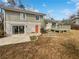 Spacious backyard with a patio, deck, and mature trees, perfect for outdoor living at 332 Hickory Acres Se Dr, Smyrna, GA 30082