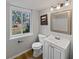 Well-lit bathroom featuring a single sink vanity and framed mirror above at 332 Hickory Acres Se Dr, Smyrna, GA 30082